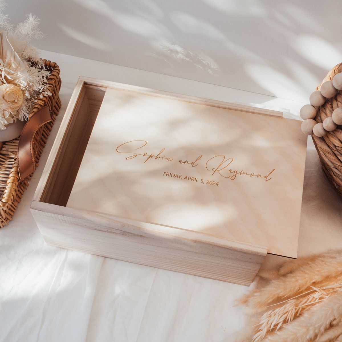 This is a large wooden wedding keepsake box with a cursive text design and a date of the wedding underneath