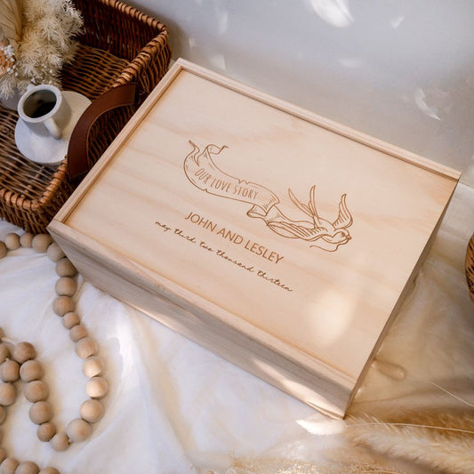 Top view - Wooden Wedding Keepsake Box with a design of a flying bird holding a banner which says "our love story". Personalised name and other details can be added